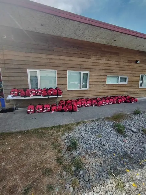 Several red bags positioned outside a building, creating a striking visual contrast with the surrounding architecture.