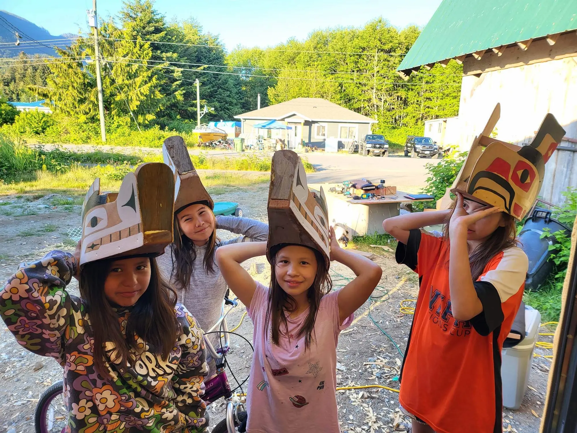 Several kids are gathered, each adorned with unique paper hats, showcasing their creativity and camaraderie.